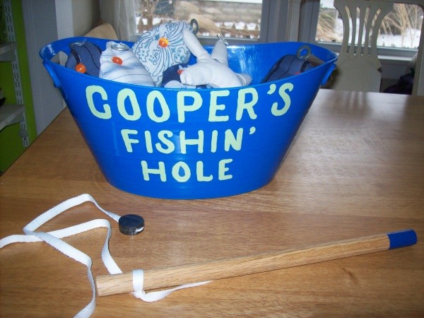 Homemade fishing game view of the bucket with pole.