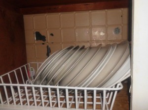 Dish drainer in cupboard.