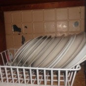 Dish drainer in cupboard.