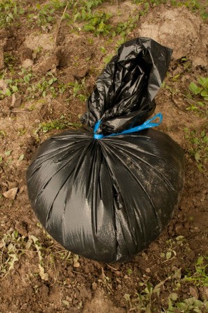 Garbage Bag Tied off on Dirt Mound