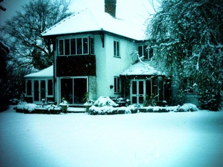 Two story house in the snow.