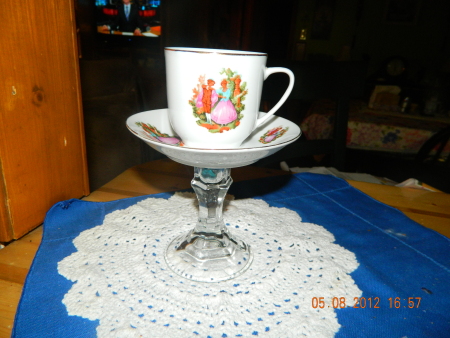 A pedestal server for a tea cup.