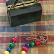 String of beads and plastic box purse.