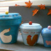 Clay pot canisters painted in blues.