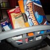 Plastic shopping cart holding food boxes repurposed as child's play food