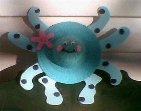Bright blue straw hat decorated as an octopus.
