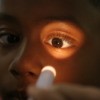 Examining a child's eyes.