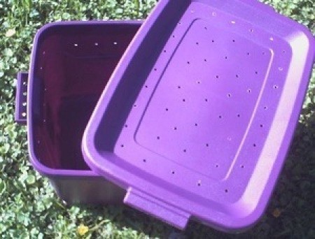 Homemade pet carrier made from a plastic tub.