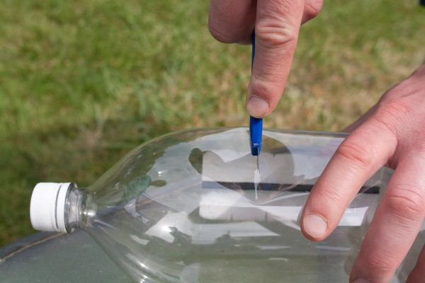 Cutting a 2 liter bottle in half.