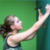 Girl Hammering Nail into Wall