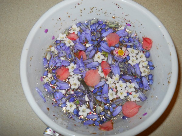 Bowl with floating flowers and added glitter.