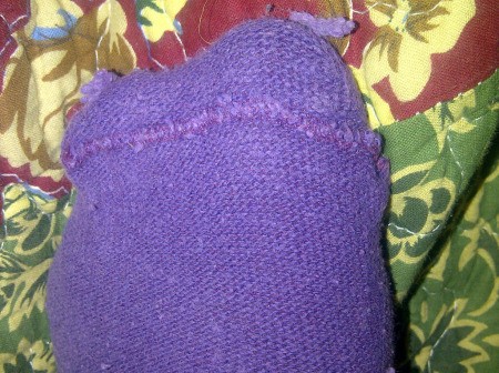 A purple sock worn inside out.