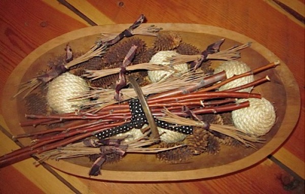 Pine needle bundles in wooden bowl with other nature decorations, such as pine cones, etc.