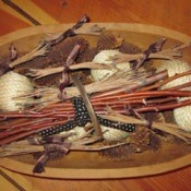 Pine needle bundles in wooden bowl with other nature decorations, such as pine cones, etc.