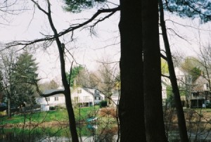 View of river with homes in the background.