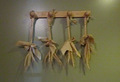 Tied stalks hanging from pegs.