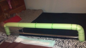 Bed rail padded with swim noodle.