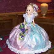 Front view of doll in pink dress.