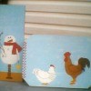Painted boards with snowman and chickens.