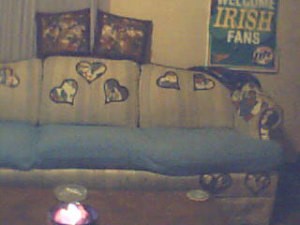 Heart shaped fabric glued onto back of couch.