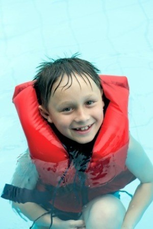 Boy in Life-vest in Swimming Pool