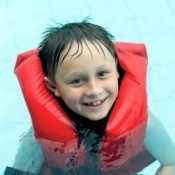 Boy in Life-vest in Swimming Pool