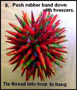 Push rubber band down and hang ornament.