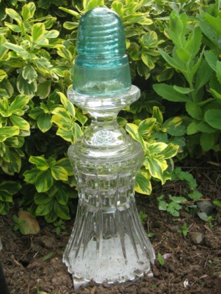 Decorative glass garden ornament made from reused glass items.