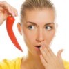 Woman Holding Her Mouth With Chili Pepper