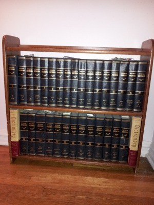 Encyclopedias on bookshelves.