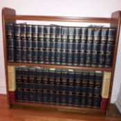 Encyclopedias on bookshelves.