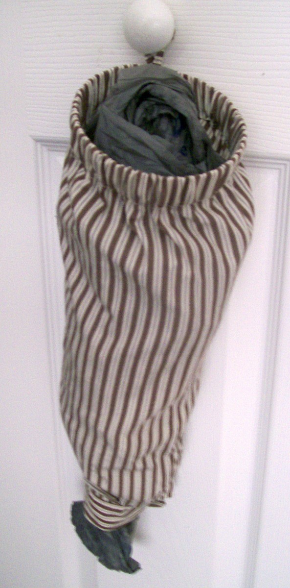 Plastic bag holder made from a shirt sleeve.