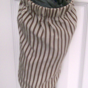 Plastic bag holder made from a shirt sleeve.