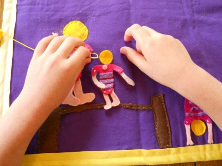 Sewing on one of the balance beam gymnasts.