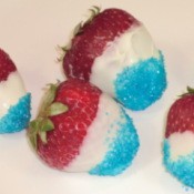 Closeup of red, white, and blue strawberries.