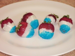 Red, white, and blue berries on a white plate.