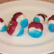 Red, white, and blue berries on a white plate.