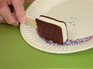 Dipping in sprinkles.