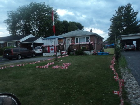 Canadian flags decorating a home and yard.