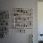 Jewelry hanging from racks, mounted on wall.