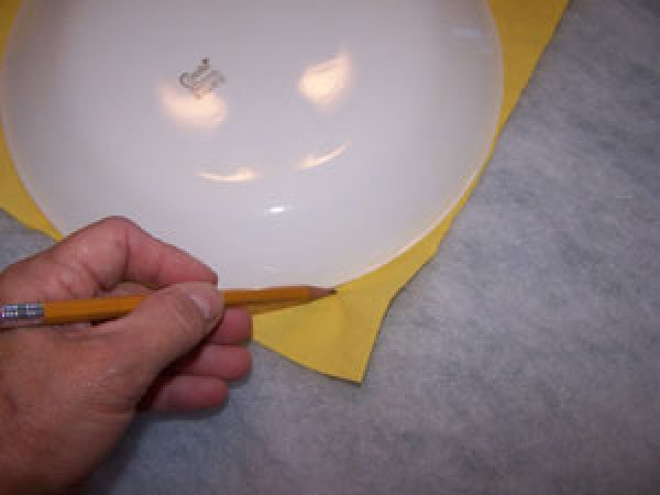 Tracing a rounded corner using a plate.