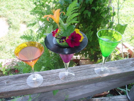 45 RPM record placed over a glass of water with flowers placed through the hole.