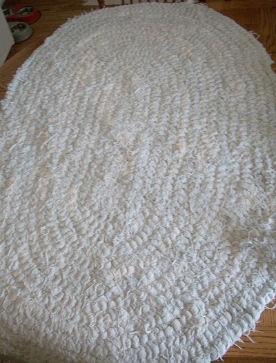 Rug made from white bedspread.