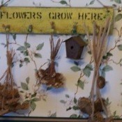 Finished project with dried flowers hanging from pegs.