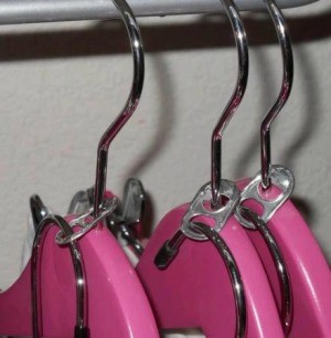 Hang another on an existing hanger using a pop can tab.