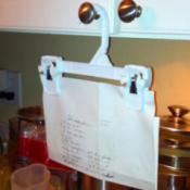 Clip hanger used for holding recipe, from cupboard knob.