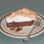 Slice of pie on plate with a fork.