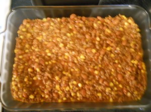 Meat and vegetable mixture in baking pan.