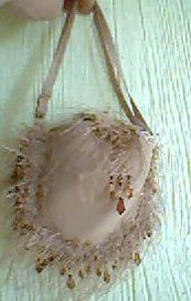 Purse made from an underwire bra with decorative edging.