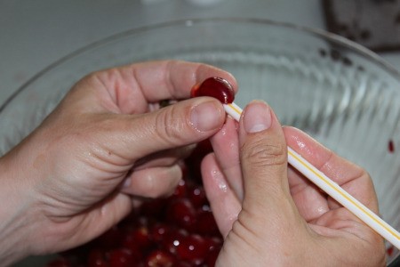Removing pits from pie cherries using a straw
